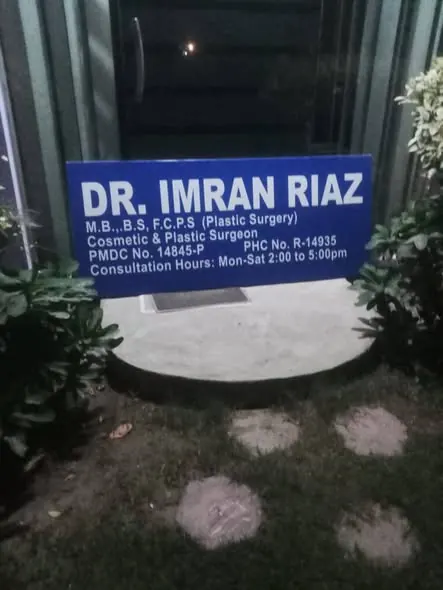 A lit clinic signboard at night