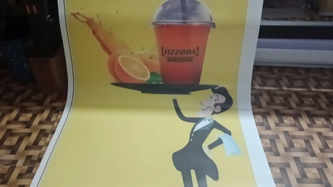 A freshly printed flex banner laid out on the floor