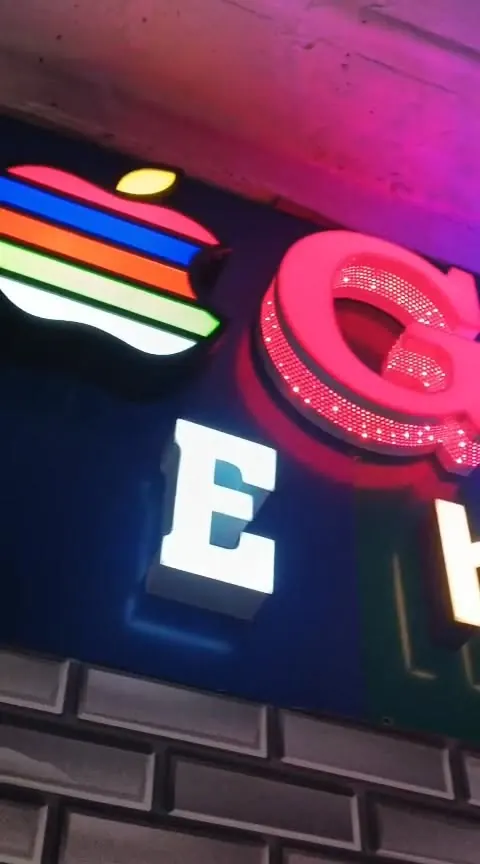 A glowing neon letter sign